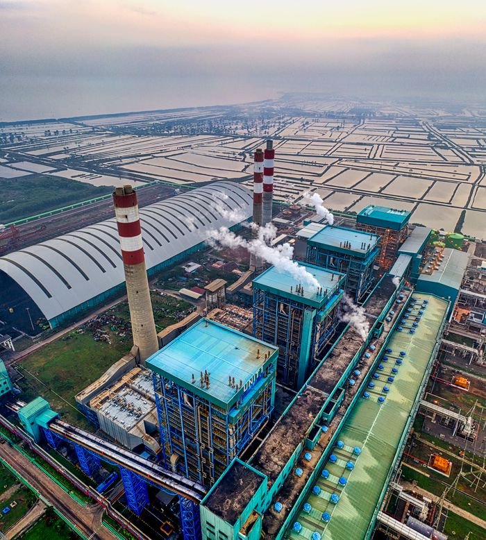 Aerial view of an industrial power plant with smokestacks in Banten, Indonesia.