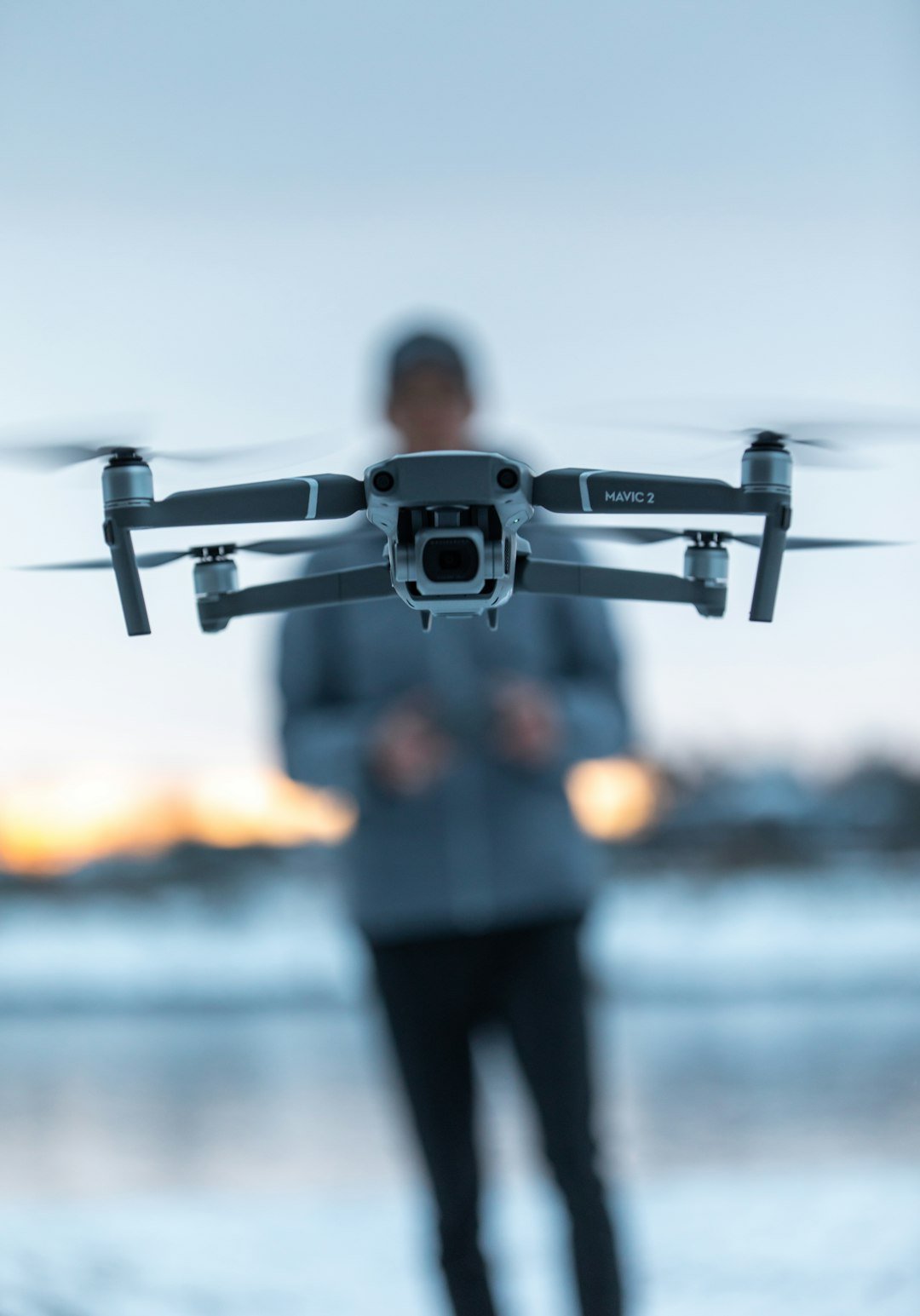 Drone pilot operating DJI Mavic 2 Pro in winter conditions